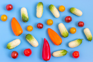 Set fresh vegetables, cucumber, tomatoes, peppers on a blue background.  Healthy food concept. Flat lay, top view.
