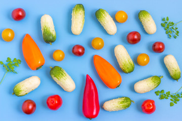 Set fresh vegetables, cucumber, tomatoes, peppers on a blue background.  Healthy food concept. Flat lay, top view.