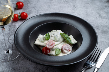Handmade seafood ravioli with trout and salmon in pesto cream sauce