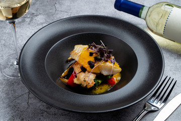 Fried halibut with mini vegetables and mango sauce as a creative chef's special meal