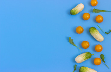 Set fresh vegetables, cucumber, tomatoes on a blue background.  Healthy food concept. Flat lay, top view.