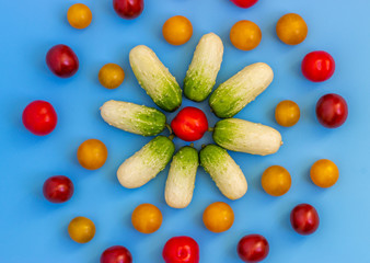 Set fresh vegetables, cucumber, tomatoes on a blue background.  Healthy food concept. Flat lay, top view.