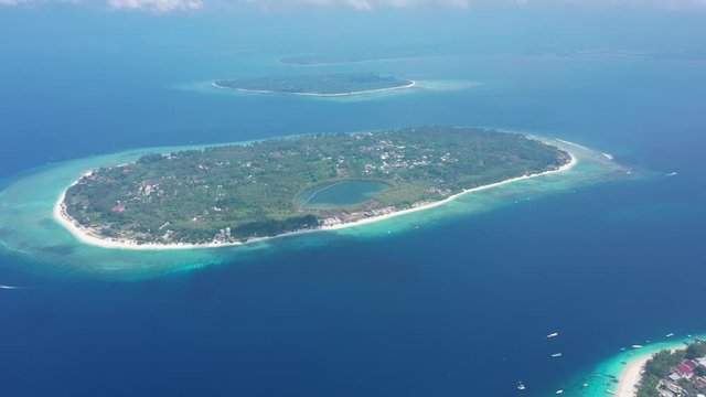 Gili island with lovely tiny buildings surrounded by green forest, Indonesia