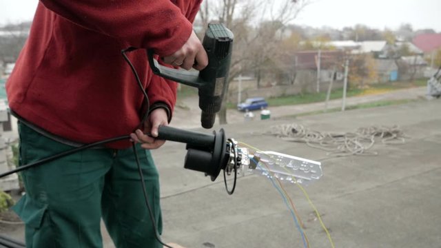 Network engineer in server room works with optical patchcord and optical module.
