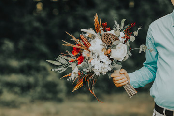 The bride and the boho flowers in her hand