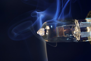 Electric light bulb with smoke photographed in the studio