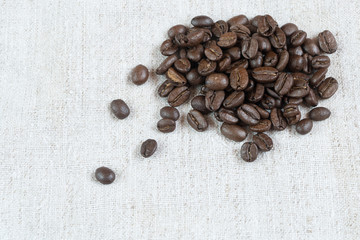 coffee beans.coffee beans sprinkled on fabric.
