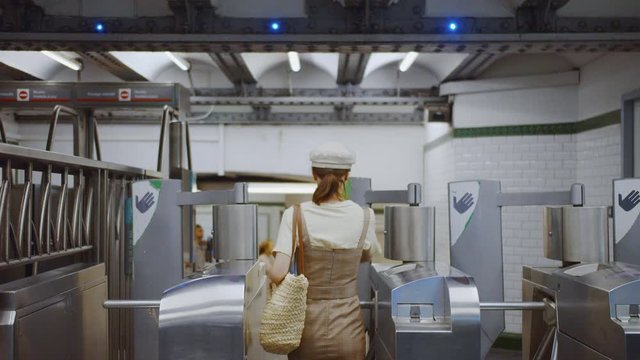Young woman going through a turnstile in a subway, Paris