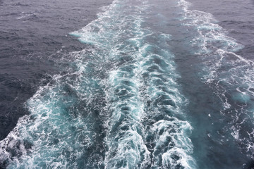 Cruise ship trail in the sea ocean waves in the background