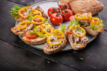 Canapes with pate, grilled sweet pepper, cherry tomatoes, lettuce and cheese. Tasty snack