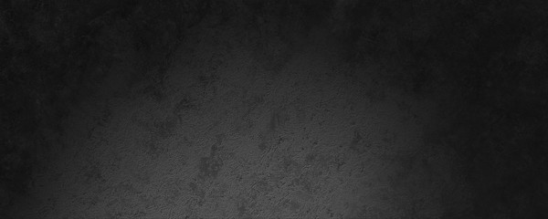 abstract dark gray concrete stone wall background illuminated by a spot