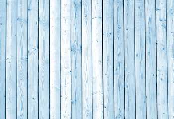 Fence made of wooden planks in blue tone.