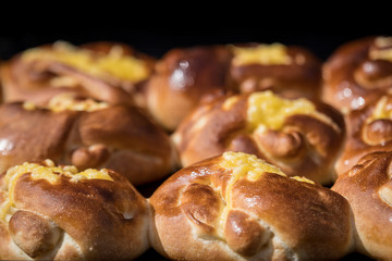 Freshly home backed cheese and vanilla buns, on display for sale at a street food market, top view or flat lay photo of healthy food photographed with selective focus