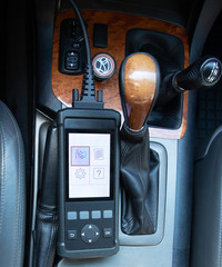 connected diagnostic car scanner in the passenger compartment, top view, close-up, main menu