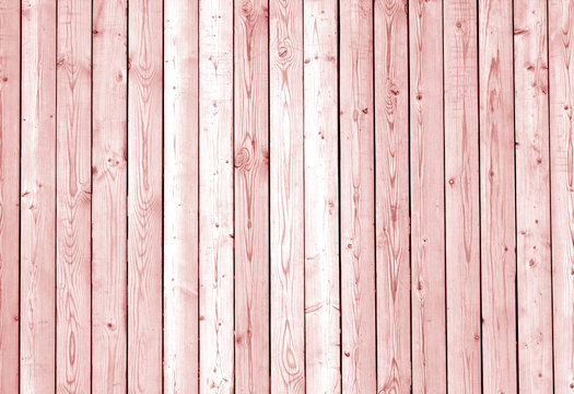 Fence made of wooden planks in red tone.