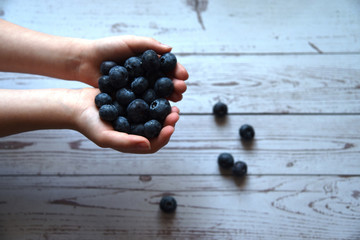 Ripe blueberries in children's hands