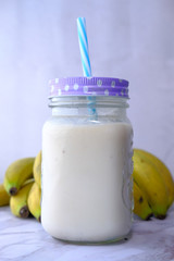 Fresh banana shake on table, close up.