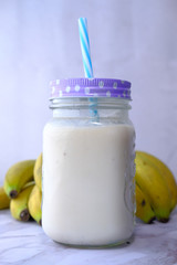 Fresh banana shake on table, close up.