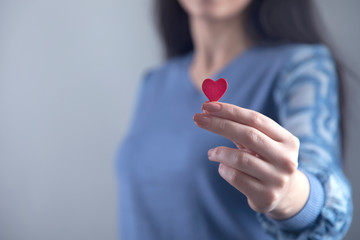woman hand red heart