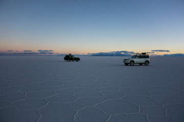 Sunset and 4x4 cars in Uyuni salar, Cordillera Real, Andes, Bolivia