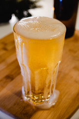glass of beer on wooden table