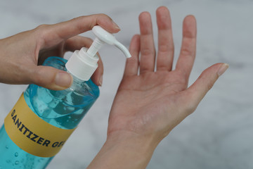 Hands using sanitizer gel pump dispenser. Transparent sanitizer in pump bottle, for killing germs, bacteria and virus.