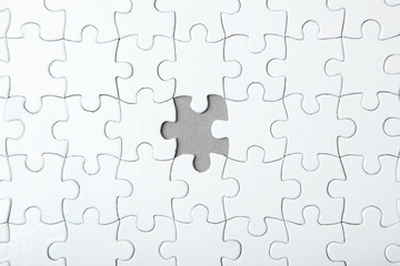 White puzzle on a colored background top view.