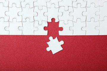 White puzzle on a colored background top view.