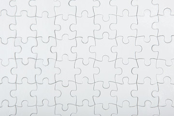 White puzzle on a colored background top view.