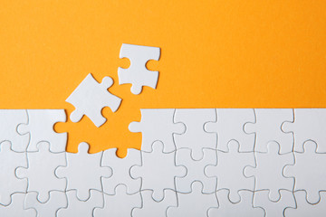 White puzzle on a colored background top view.