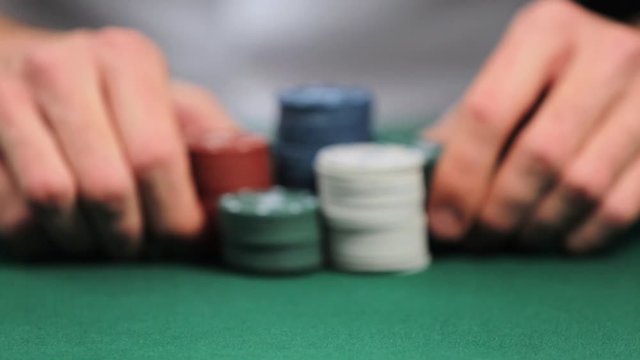 Man playing poker in casino, closeup