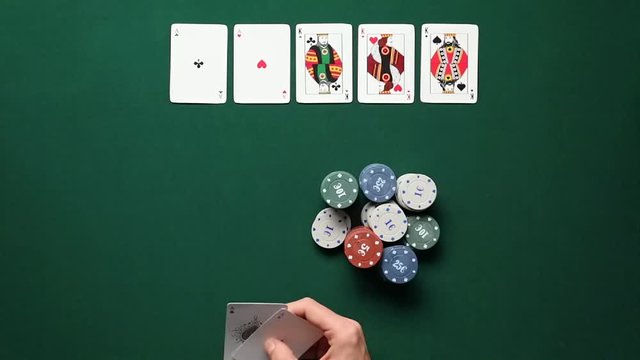 Man playing poker in casino, top view