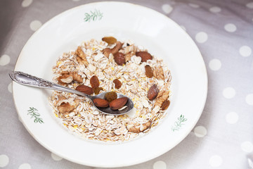 Oatmeal in bowl with nuts, useful food