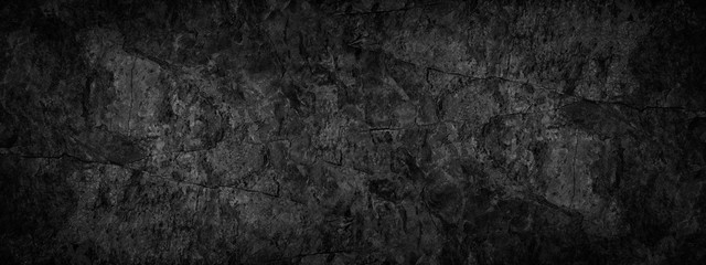 Black grunge background. Texture of cracked stone surface. Black rock grunge background with copy space for your design.