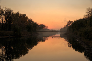 Sunset over the river in the park