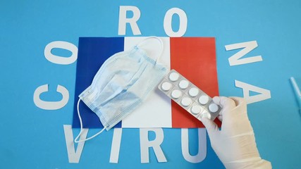 covid - 19, 2019-nCoV virus concept. Coronavirus word from letters, mask and pills and France flag on blue background, coronavirus epidemic in France - Powered by Adobe