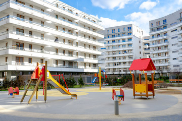 Fototapeta na wymiar Warsaw, Poland- 23/03/2020-Colorful playground in the yard against the background of residential buildings.