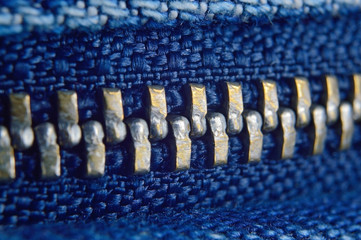 metal zipper on blue jeans. macro © Oleg