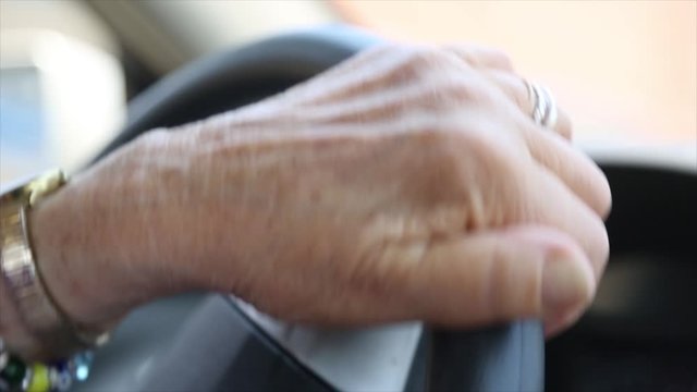 Camera focuses on old woman's hands.