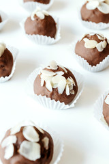 Homemade chocolates with almond chips. Vegan dessert.