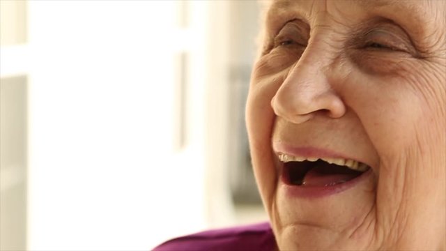 Elderly woman is laughing