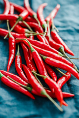 Macro photography of chili peppers on a blue linen.