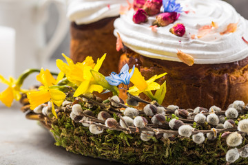 Fototapeta na wymiar Easter Cake - Russian and Ukrainian Traditional Kulich or Brioche on a light stone background. Paska or Panettone Bread and spring flowers