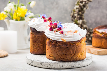 Easter Cake - Russian and Ukrainian Traditional Kulich or Brioche on a light stone background. Paska or Panettone Bread  and spring flowers