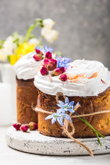 Easter Cake - Russian and Ukrainian Traditional Kulich or Brioche on a light stone background. Paska or Panettone Bread  and spring flowers