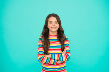 Fototapeta premium Nice time to be child. Kid fashion. Smiling school girl. Kid long hair. Happy child. Happy childrens day. Childhood concept. Little girl turquoise background. Shopping day. Items for small girl