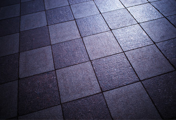 Symmetrical tiles of street pavement background