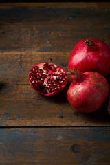 Several pomegranates on wood boards
