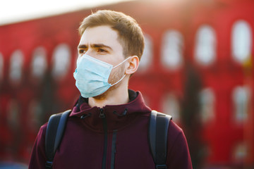 Portrait of men in protective sterile medical mask on her face on the street city. The concept of preventing the spread of the epidemic and treating coronavirus, pandemic in quarantine city. Covid-19.