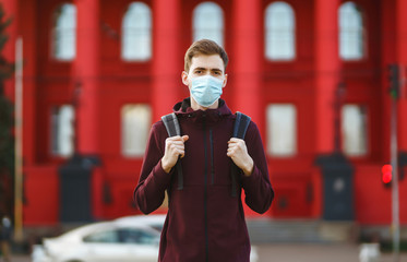 Portrait of men in protective sterile medical mask on her face on the street city. The concept of preventing the spread of the epidemic and treating coronavirus, pandemic in quarantine city. Covid-19.